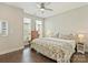 Bright bedroom showcasing hardwood floors, a ceiling fan, and large windows at 520 Sedgefield Park Dr, Charlotte, NC 28203