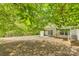 Expansive backyard featuring mature trees and a patio, perfect for outdoor entertaining and relaxation at 5206 Fire Water Ln, Fort Mill, SC 29707