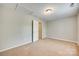 This bright bedroom features neutral carpet and a ceiling access panel at 5206 Fire Water Ln, Fort Mill, SC 29707