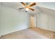 A bedroom featuring neutral walls, carpet, ceiling fan, and closet at 5206 Fire Water Ln, Fort Mill, SC 29707