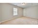A cozy bedroom featuring neutral walls, carpet, and a bright window at 5206 Fire Water Ln, Fort Mill, SC 29707