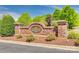 A brick community entrance sign surrounded by vibrant landscaping, creating a welcoming atmosphere at 5206 Fire Water Ln, Fort Mill, SC 29707