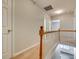 Hallway with white railing and natural lighting from the lower level at 5206 Fire Water Ln, Fort Mill, SC 29707