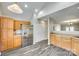 Well-lit kitchen featuring wood cabinets, stainless steel refrigerator, and modern flooring at 5206 Fire Water Ln, Fort Mill, SC 29707