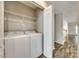 A laundry room with shelving and appliances is located on the main floor of the house at 5206 Fire Water Ln, Fort Mill, SC 29707