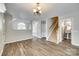 Open-concept layout featuring living room with wood floors and staircase at 5206 Fire Water Ln, Fort Mill, SC 29707