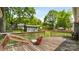 Backyard deck overlooking lush green lawn and storage shed at 6915 Norchester Ct, Charlotte, NC 28227
