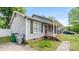 Exterior view of a charming home with a covered porch and lush greenery at 6915 Norchester Ct, Charlotte, NC 28227