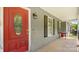 Inviting front porch featuring a red door and classic design elements at 6915 Norchester Ct, Charlotte, NC 28227