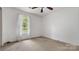 A clean bedroom with a window and neutral carpet at 6915 Norchester Ct, Charlotte, NC 28227