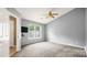 Bedroom boasts neutral carpet, ceiling fan and natural light from a window at 6915 Norchester Ct, Charlotte, NC 28227