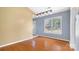 Dining area with hardwood floors, window, and view to the backyard at 6915 Norchester Ct, Charlotte, NC 28227