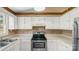 Kitchen features white cabinets and modern appliances at 6915 Norchester Ct, Charlotte, NC 28227