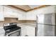 Bright kitchen features stainless steel refrigerator and stove at 6915 Norchester Ct, Charlotte, NC 28227