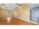 Inviting living room featuring hardwood floors, natural light and a modern light fixture at 6915 Norchester Ct, Charlotte, NC 28227