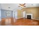 Spacious living room features hardwood floors, fireplace, and ample natural light at 6915 Norchester Ct, Charlotte, NC 28227