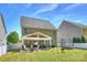 Home's backyard showcasing a covered patio with a dining and trampoline at 79115 Ridgehaven Rd, Lancaster, SC 29720