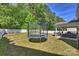 Spacious backyard featuring a trampoline and a covered patio area with outdoor furniture at 79115 Ridgehaven Rd, Lancaster, SC 29720