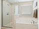 Bright bathroom features a walk-in shower with glass doors and a relaxing soaking tub at 79115 Ridgehaven Rd, Lancaster, SC 29720
