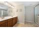 Well-lit bathroom boasts double vanity, a large mirror, and a separate glass-enclosed shower at 79115 Ridgehaven Rd, Lancaster, SC 29720