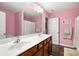 Bright bathroom with double sink vanity, pink walls, and decorative accents create a charming space at 79115 Ridgehaven Rd, Lancaster, SC 29720