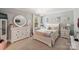 Charming bedroom decorated in soothing grays and whites with stylish chandelier and decor at 79115 Ridgehaven Rd, Lancaster, SC 29720