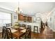Well-lit dining room features a chandelier, a wood table with seating for six, and an open view to the kitchen at 79115 Ridgehaven Rd, Lancaster, SC 29720