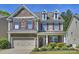 Charming two-story home featuring stone accents, red shutters, a manicured lawn, and an attached two-car garage at 79115 Ridgehaven Rd, Lancaster, SC 29720