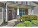 Inviting front porch featuring stone columns, a decorative wreath, and lush landscaping at 79115 Ridgehaven Rd, Lancaster, SC 29720
