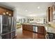 Kitchen features wooden cabinets, stainless steel appliances, granite countertops, and an open floor plan to the living room at 79115 Ridgehaven Rd, Lancaster, SC 29720