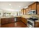 Spacious kitchen features stainless steel appliances, wooden cabinets, granite countertops and tile backsplash at 79115 Ridgehaven Rd, Lancaster, SC 29720