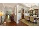 Open-concept dining room with elegant chandelier, decorative moldings, and hardwood floors at 79115 Ridgehaven Rd, Lancaster, SC 29720