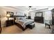 Spacious primary bedroom suite with a tray ceiling, ceiling fan, and ample natural light at 79115 Ridgehaven Rd, Lancaster, SC 29720