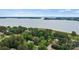 Stunning aerial view of a home near the lake surrounded by lush greenery at 8032 Turnberry Ln, Stanley, NC 28164