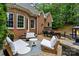 Inviting brick back patio, featuring comfortable seating, string lights, and a cozy outdoor atmosphere at 8032 Turnberry Ln, Stanley, NC 28164