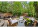 A charming backyard patio features a full outdoor dining set and a separate cozy seating area at 8032 Turnberry Ln, Stanley, NC 28164