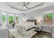 Well-lit bedroom with a tray ceiling, large windows, and exercise bike at 8032 Turnberry Ln, Stanley, NC 28164