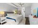 Neutral bedroom featuring a ceiling fan, white comforter, and wood flooring at 8032 Turnberry Ln, Stanley, NC 28164
