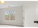 A bright bedroom featuring a large window, neutral carpet, white walls, and white trim at 8032 Turnberry Ln, Stanley, NC 28164