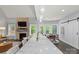 Bright, open kitchen features marble countertop and an adjacent dining area with a fireplace at 8032 Turnberry Ln, Stanley, NC 28164