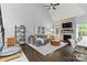 Living area with open-concept kitchen, featuring modern decor and a stone fireplace at 8032 Turnberry Ln, Stanley, NC 28164