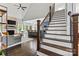 Inviting living room with open floor plan, fireplace, and hardwood floors at 8032 Turnberry Ln, Stanley, NC 28164