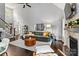 Spacious living room with high ceilings, fireplace, and open staircase at 8032 Turnberry Ln, Stanley, NC 28164