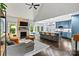 Stylish living room with fireplace and open to the kitchen with large island at 8032 Turnberry Ln, Stanley, NC 28164
