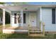Inviting front porch with decorative railings and freshly painted stairs leading to the entrance at 872 Wellman St, Gastonia, NC 28054