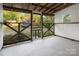 View of a screened porch with wooden crossbeams and a concrete floor at 872 Wellman St, Gastonia, NC 28054