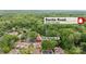 An aerial shot displays a neighborhood close to Sardis Road surrounded by lush trees and a quiet community at 8326 Ramath Dr, Charlotte, NC 28211
