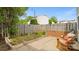 Cozy backyard with a brick and wood fence, a small garden area, and wooden rocking chairs at 8326 Ramath Dr, Charlotte, NC 28211