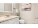 Bathroom featuring a vanity sink, toilet, neutral color scheme, and modern fixtures at 8326 Ramath Dr, Charlotte, NC 28211