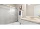 This bathroom features a tub with sliding glass doors and a cream colored vanity at 8326 Ramath Dr, Charlotte, NC 28211